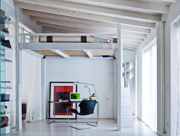 White Rising raised under exposed beams, a desk underneath